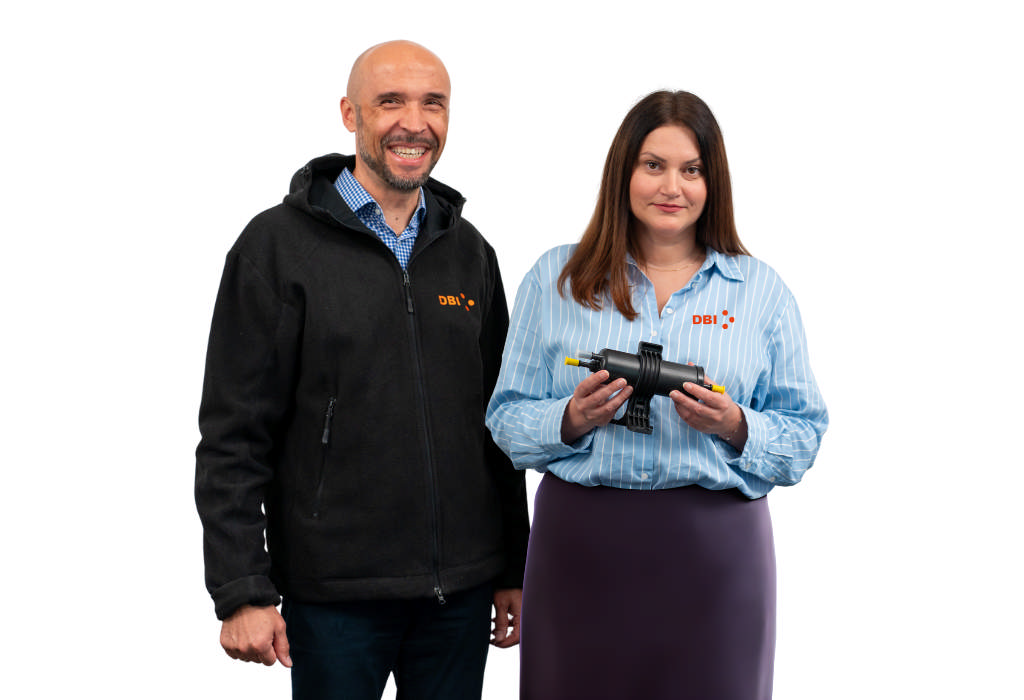 Two DBI employees holding an oil filter with DBI protective caps